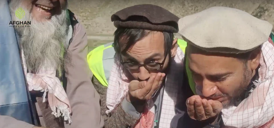 Two elderly Afghan men in traditional dress at a Foundation relief distribution